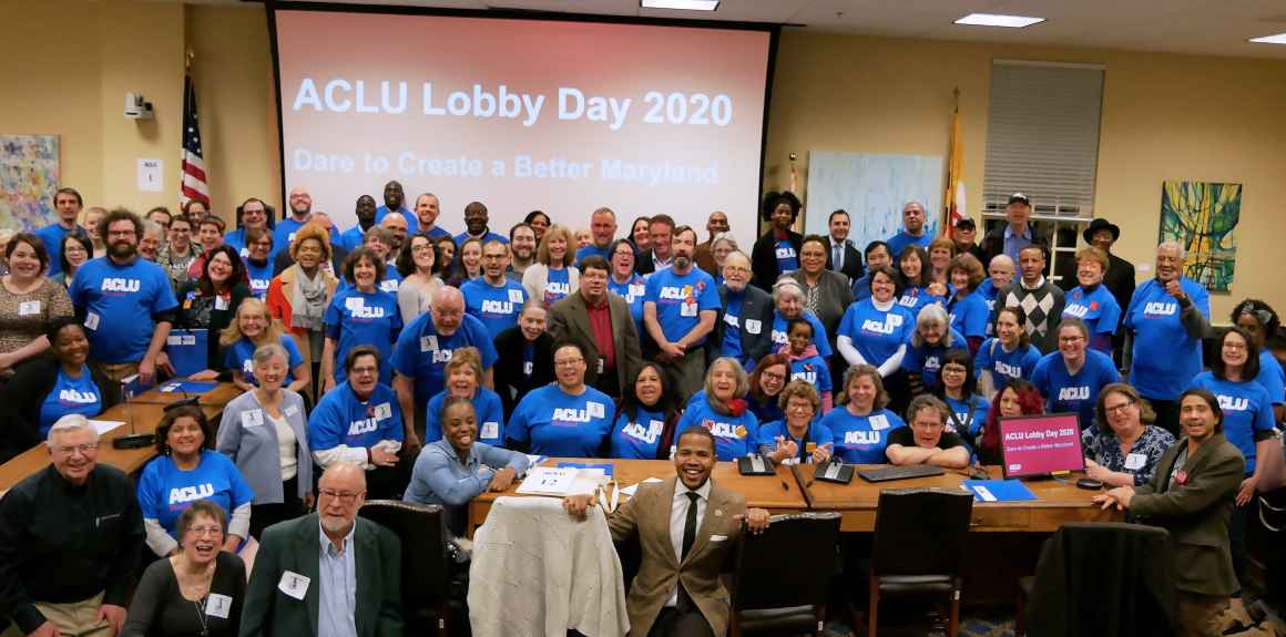 ACLU of Maryland members in a big group photo with most people wearing blue ACLU t-shirts. There are about 100 people in this photo.