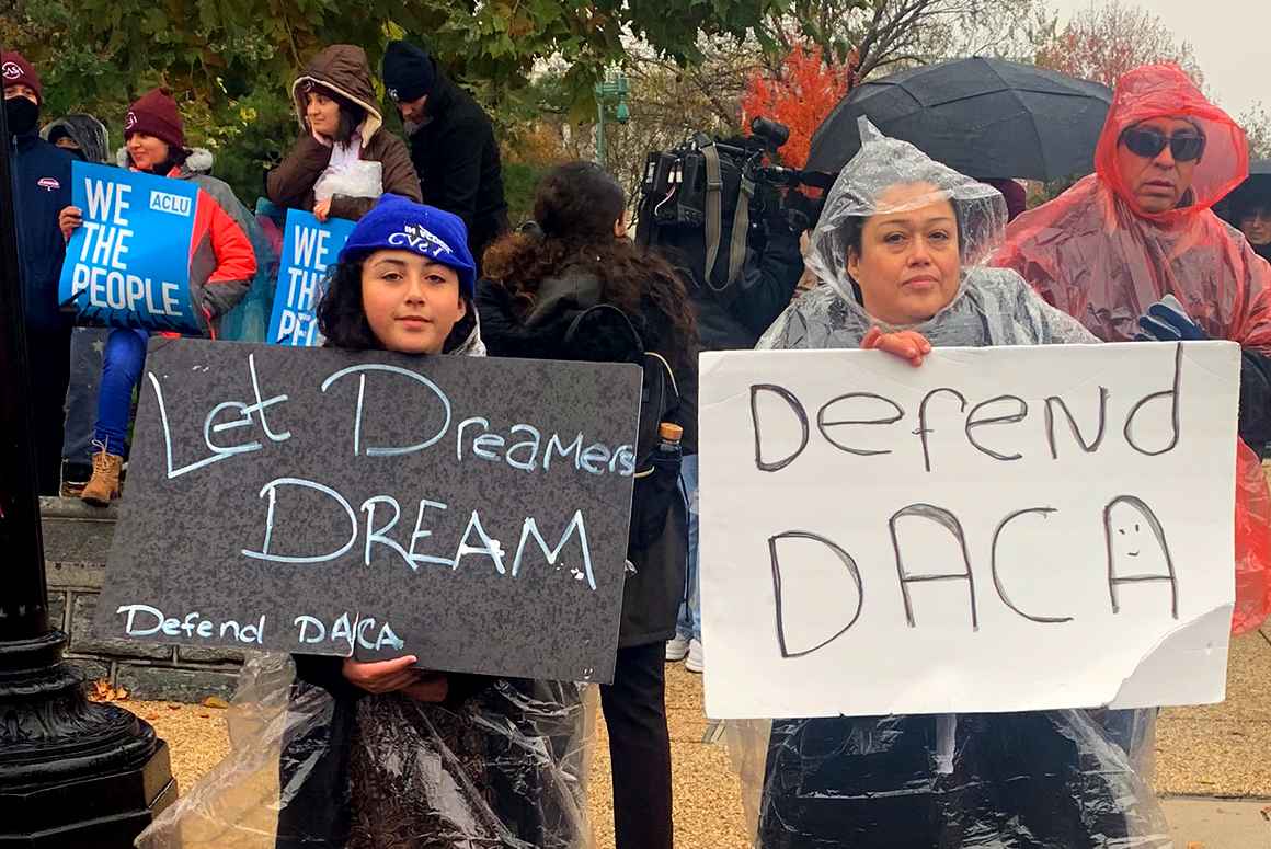 Two people at the Home is Here rally at the Supreme Court holding signs that say "Let Dreamers Dream" and "Defend DACA". In the background are two people holding ACLU signs that say "We the People".