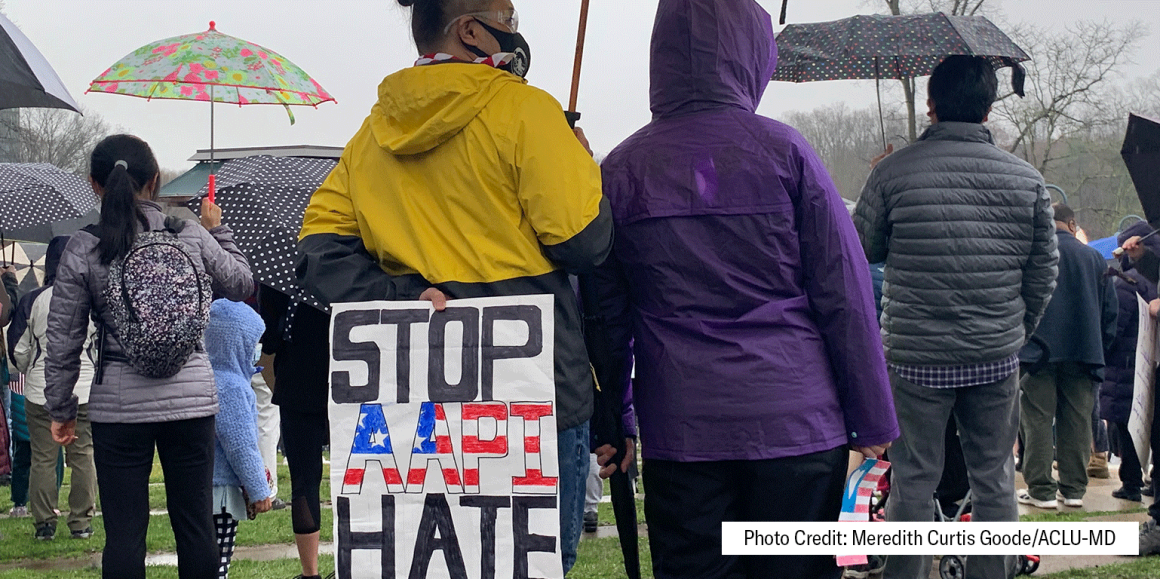 Person at a rally holds a sign behind their back that says, "Stop AAPI hate." Photo credit: Meredith Curtis Goode/ACLU-MD