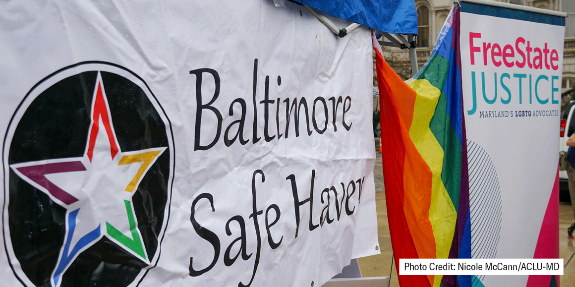 Baltimore Safe Haven banner and FreeState Justice vertical sign. There is a rainbow flag in the middle. Photo credit: Nicole McCann/ACLU-MD