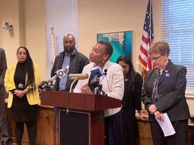 Delegate Pamela Queen spoke out against the currently unjust parole system at a parole reform press conference. She is standing at the podium with several people behind her.