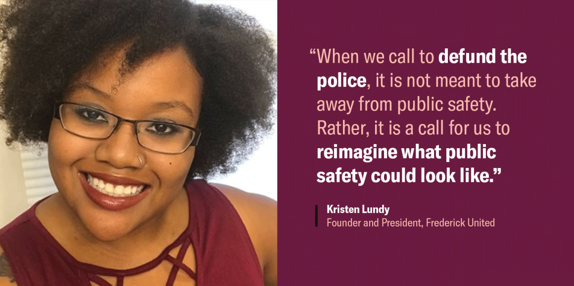Image shows Kristen Lundy, a Black Latina, with short curly texture hair, wearing glasses, and smiling. The quote says, "“When we call to defund the police, it is not meant to take away from public safety..."