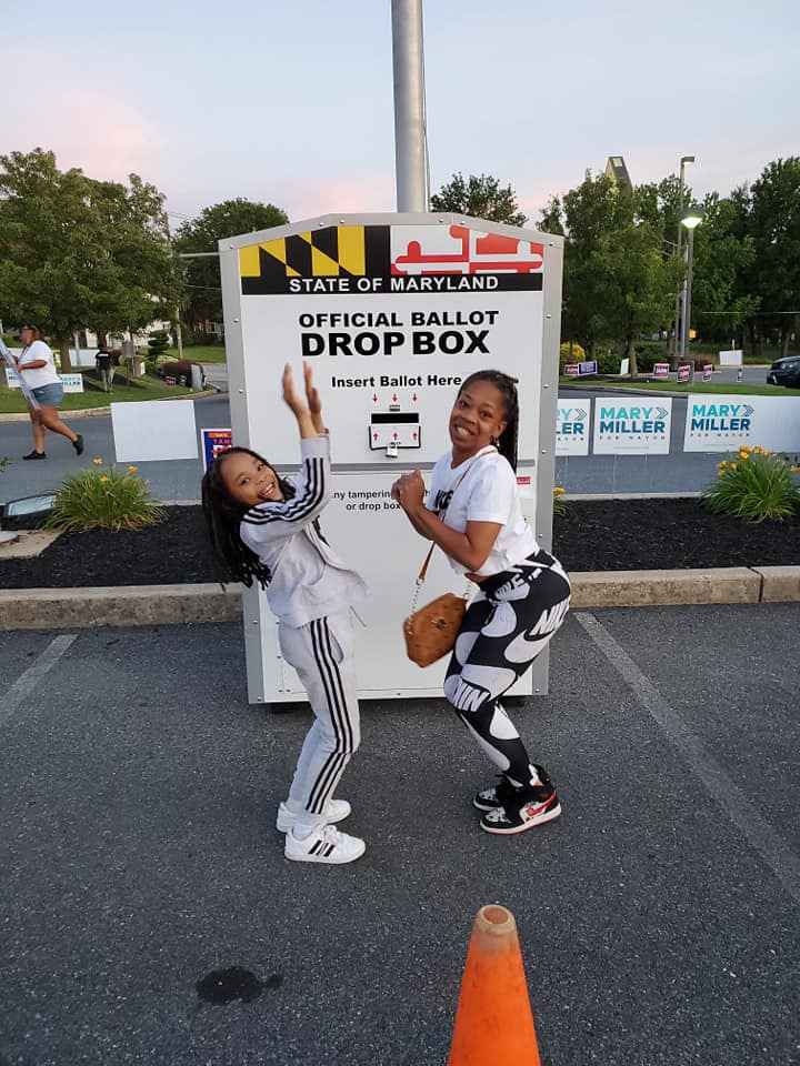 Nicole Hanson Mundell and her daughter are dropping off her ballot at a drop box.