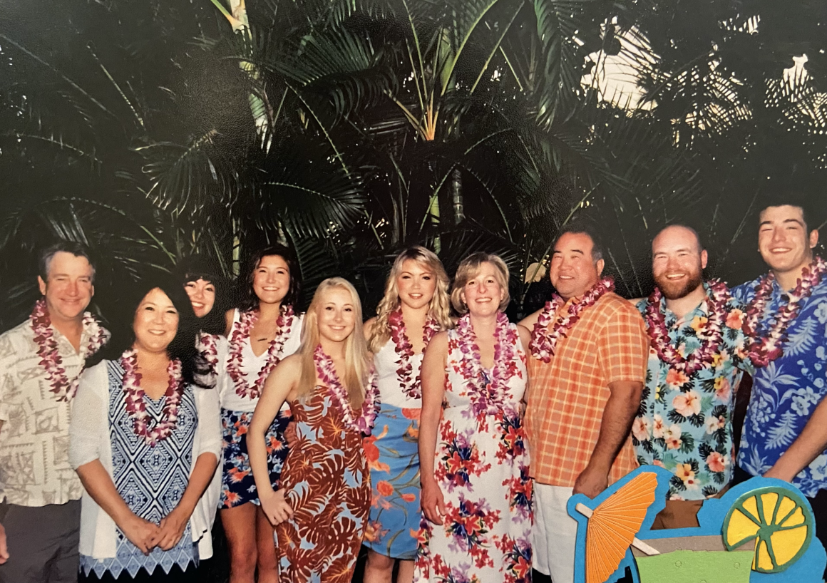 Olivia Spaccasi is standing in a group photo of extended family. They are wearing leis.