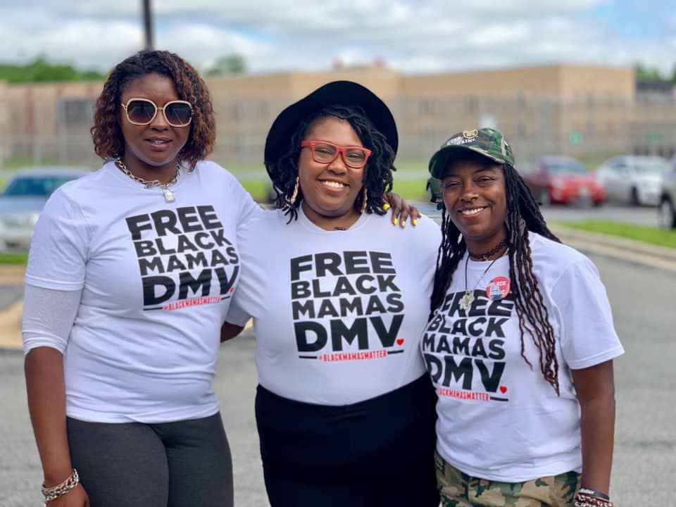 Qiana Johnson, on the left, is with two other Black people wearing t-shirts that say "Free Black Mamas DMV".