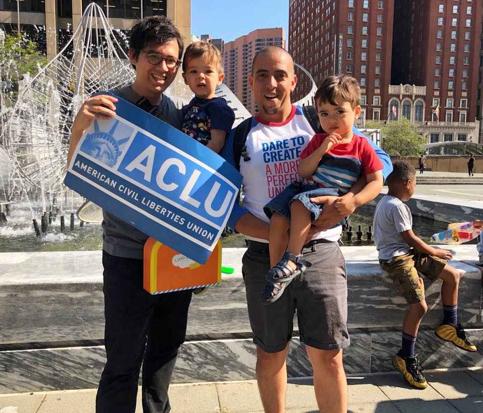 Sergio Espana and Nick Taichi Steiner with their children at Sanctuary DMV rally