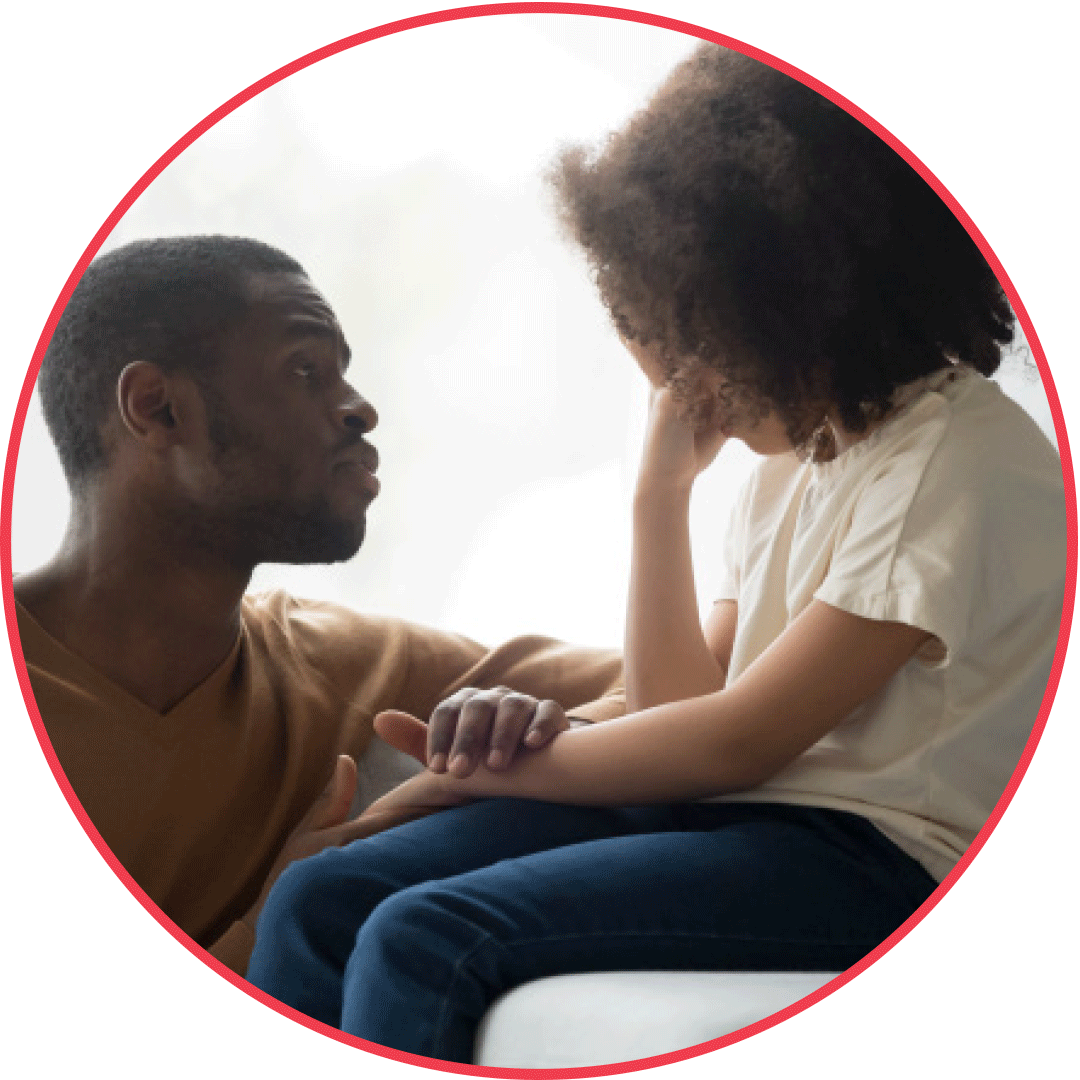 A circular image shows a Black parent or guardian who is giving care and support to a Black child who is upset.