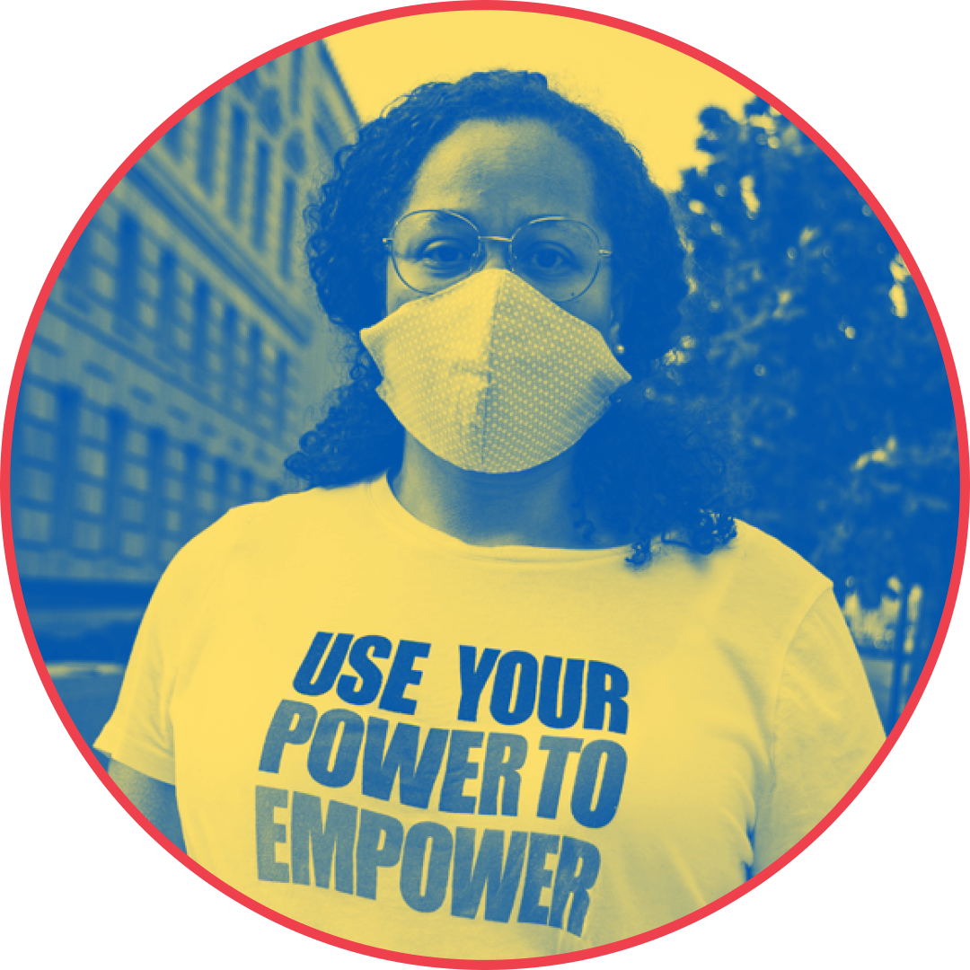 A circular image shows a Black person with below the shoulders curly dark hair wearing a t-shirt that says "use your power to empwer." The image is blue and yellow.