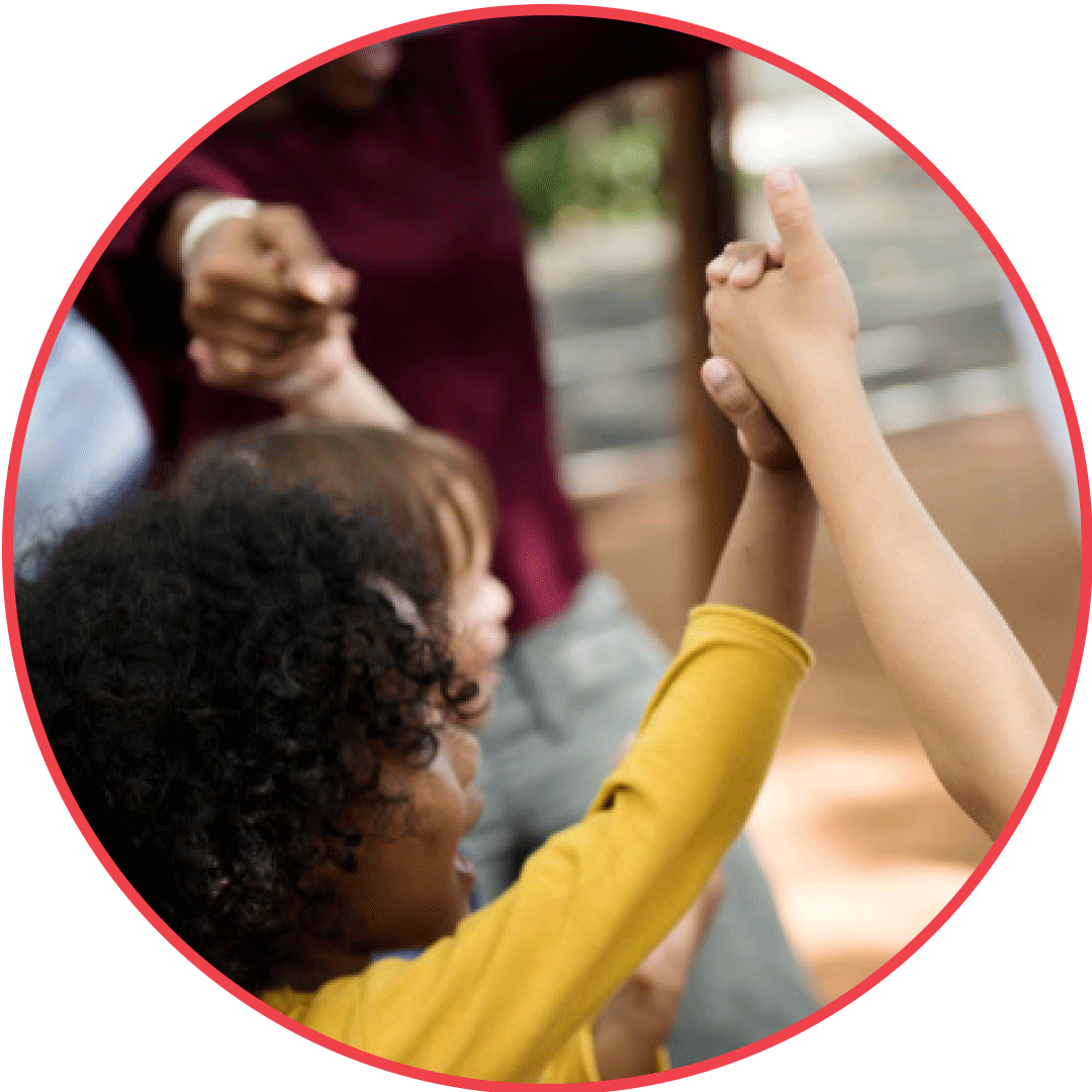 A circular image shows children holding hands with other children and an adult in a circle. There is a Black child with curly hair in the forefront and a white child somewhat visible behind them.