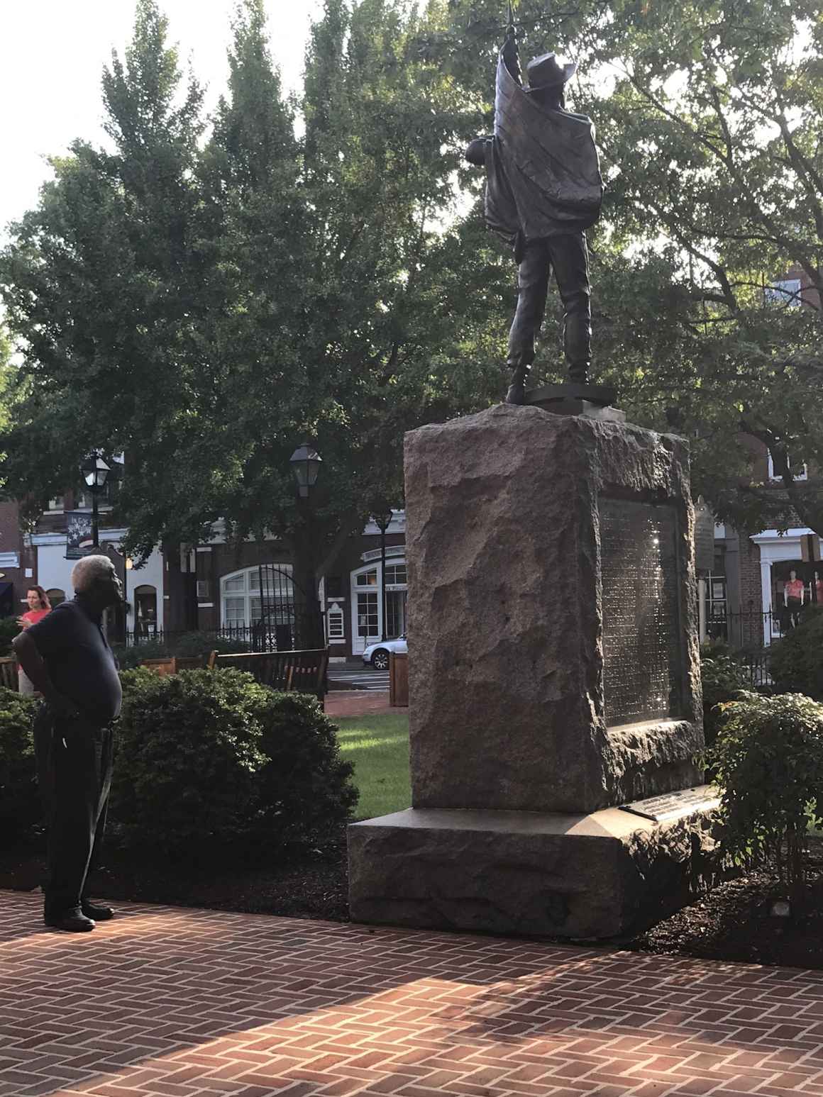 A Black man looks at the Talbot County Confederate statue in Easton, Maryland.