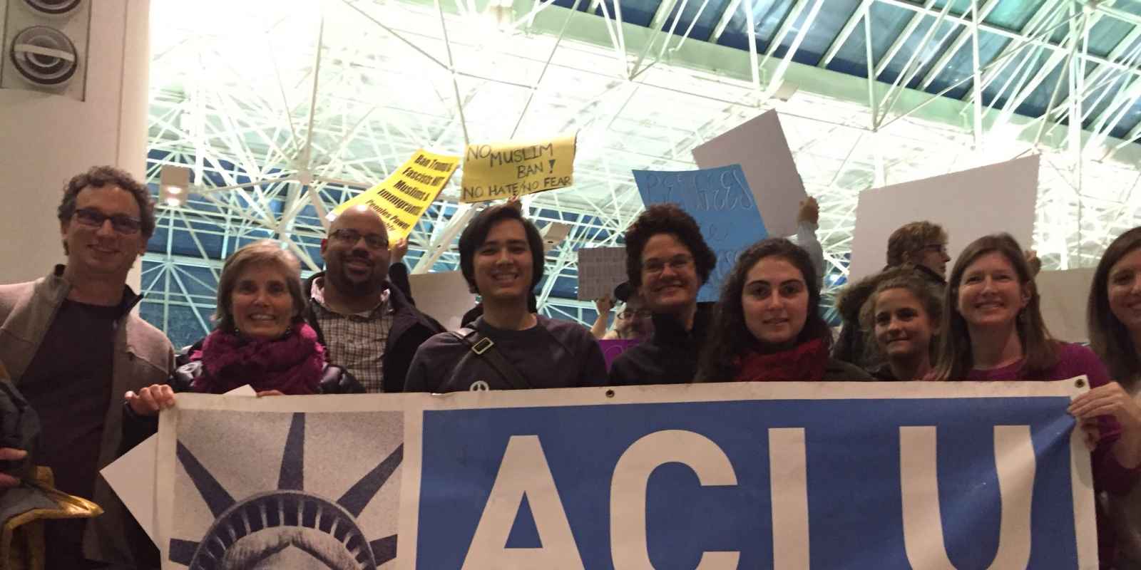 Group photo of ACLU of Maryland staff at BWI airport to support Muslim people arriving who were impacted by Trump's Muslim ban.