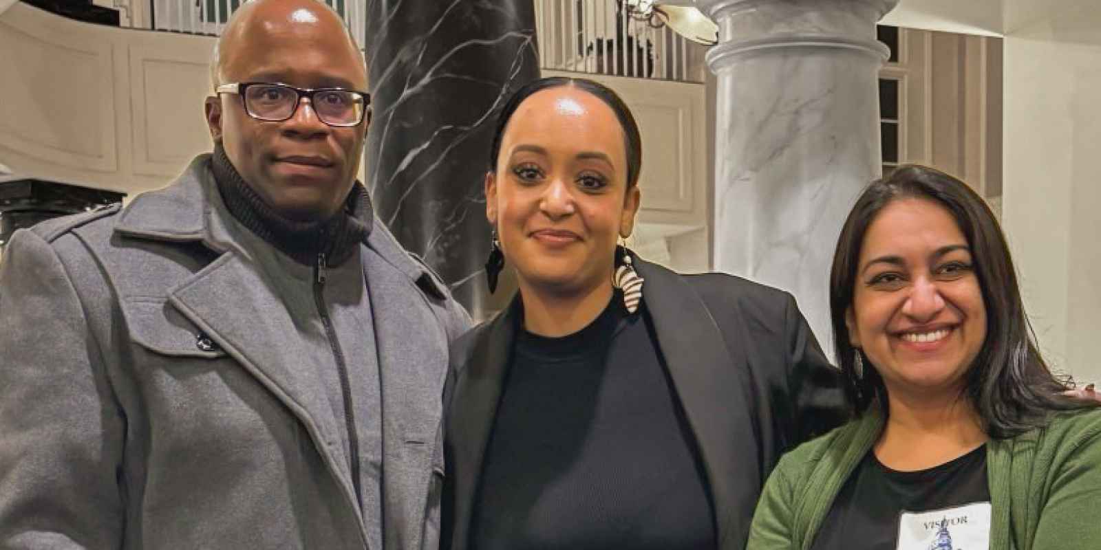 Anthony Muhammad, Yanet Amanuel, and Sonia Kumar stand together in the Maryland chamber houses on the day of a hearing in the House Judiciary Committee for the Maryland Second Look Act.