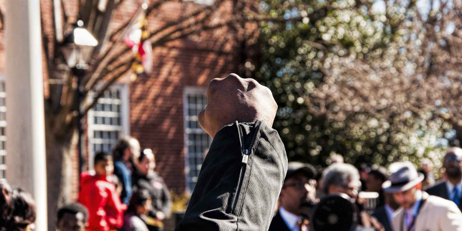 Black person's raised fist at a protest in Maryland. 