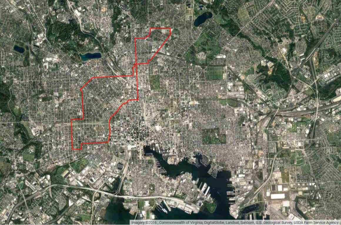Aerial view of Baltimore with red line drawn around area under mass surveillance.