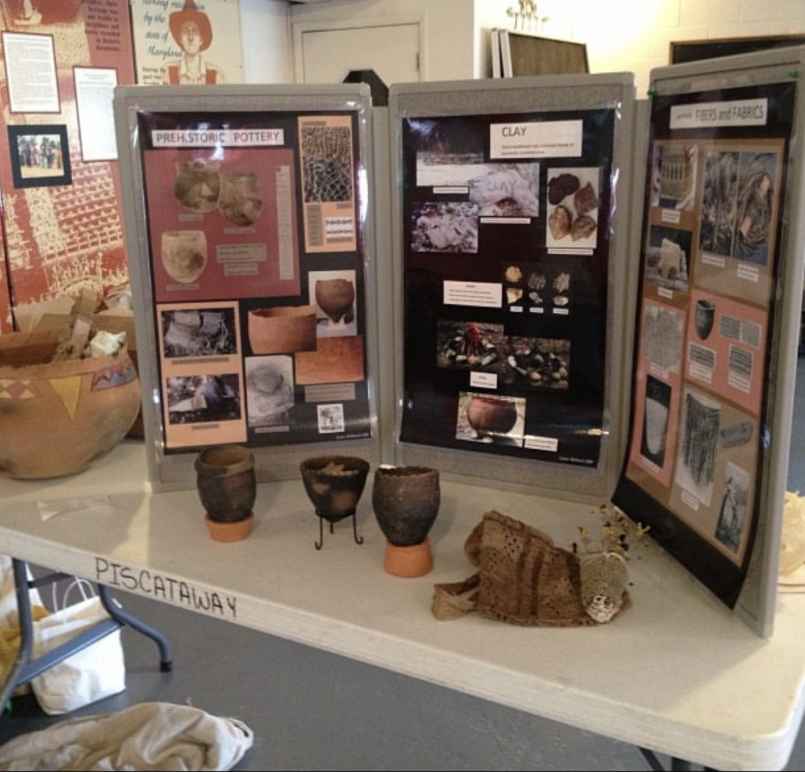 Display of history, photos, and pieces of pottery from a class the Cedarville Band of the Pisctaway Indians offered at their cultural center.