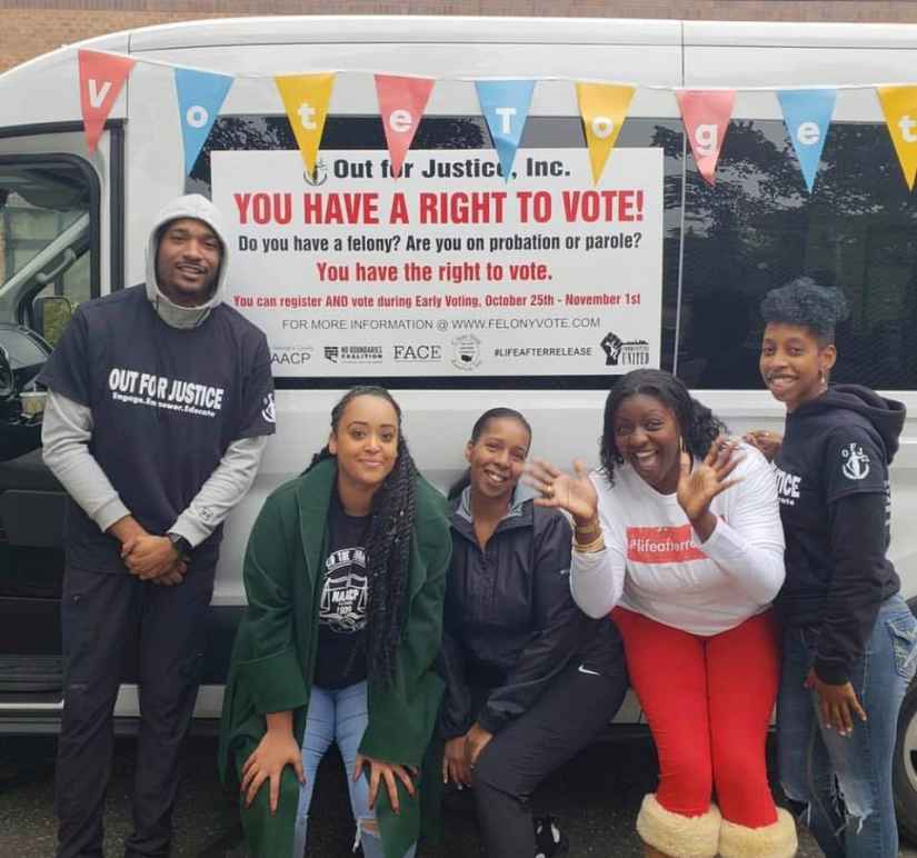  Expand the vote coalition group of people in front of a van with a sign that says, "You have a right to vote!"