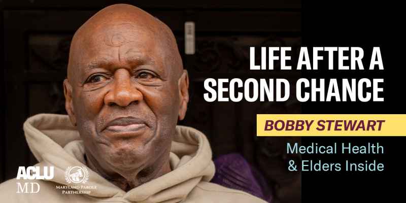 Bobby Stewart is a Black man with a beige hoodie, looking to the left, with a slight smile on his face. He is standing outside on a porch.