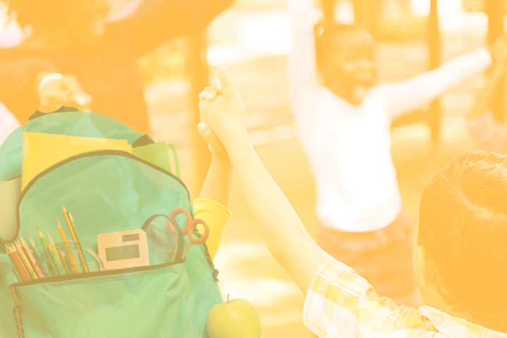 Photo of a teacher and children in a circle holding hands with happy expressions. The photo has a yellow and white gradient overlay. There's a backpack cutout in the bottom left.