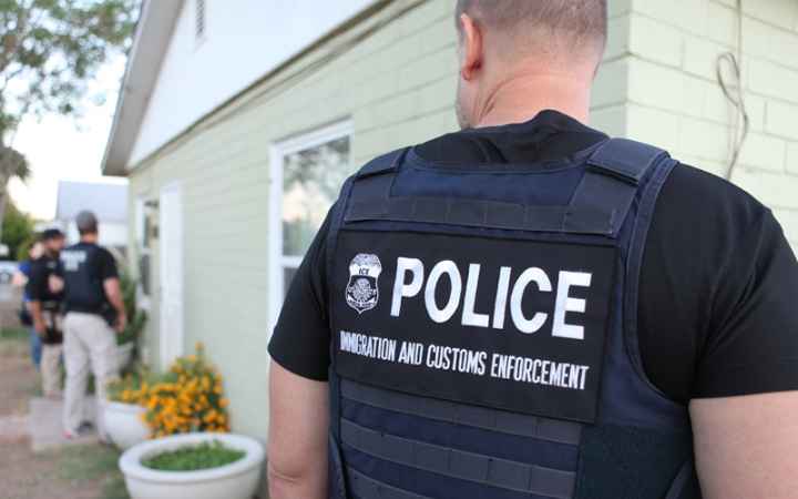 Several ICE officers are at a person's home.