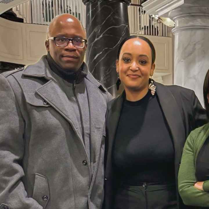 Anthony Muhammad, Yanet Amanuel, and Sonia Kumar stand together in the Maryland chamber houses on the day of a hearing in the House Judiciary Committee for the Maryland Second Look Act.