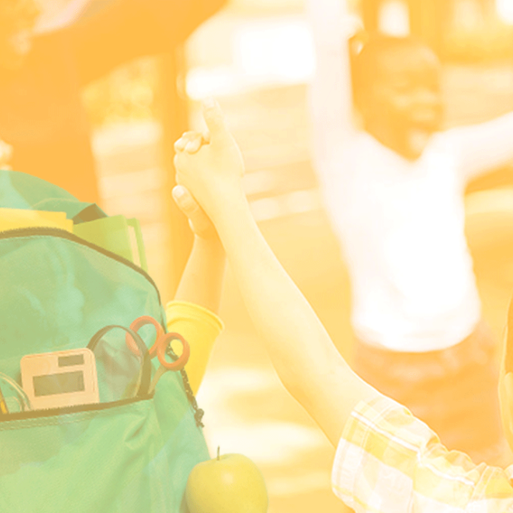 Photo of a teacher and children in a circle holding hands with happy expressions. The photo has a yellow and white gradient overlay. There's a backpack cutout in the bottom left.