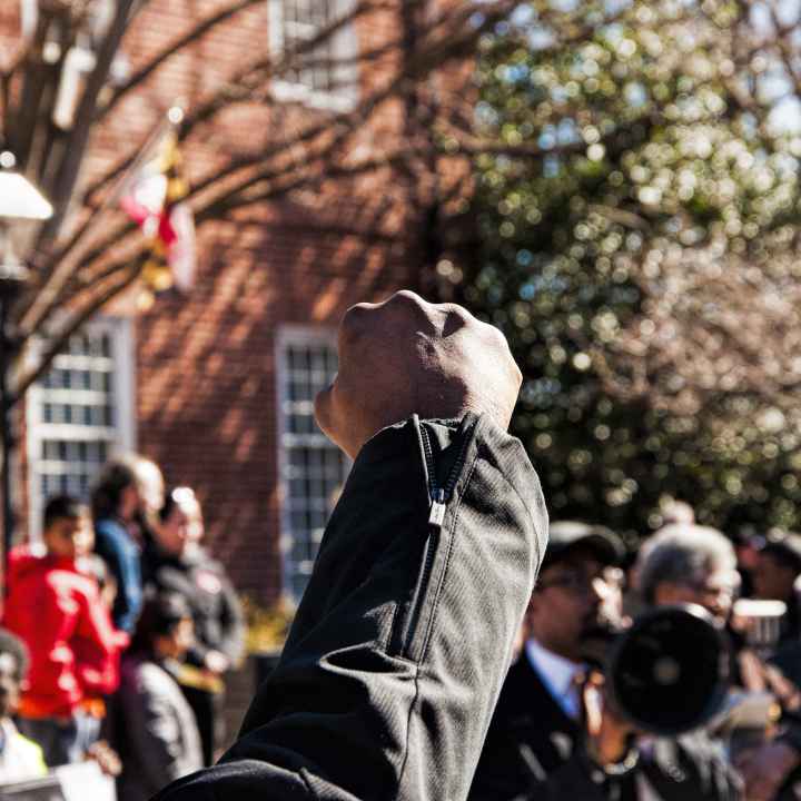Black person's raised fist at a protest in Maryland. 