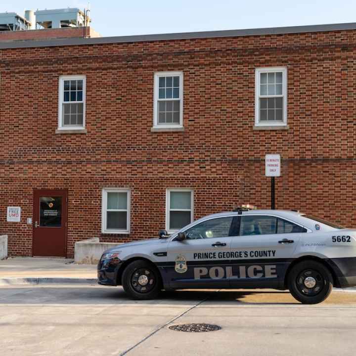 Prince George's County police cruiser in front of a brick building