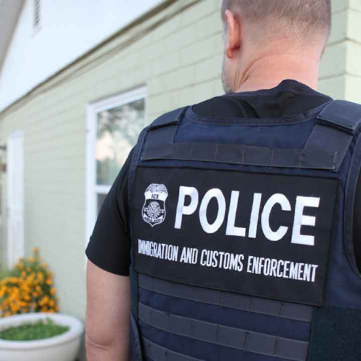 Several ICE officers are at a person's home.